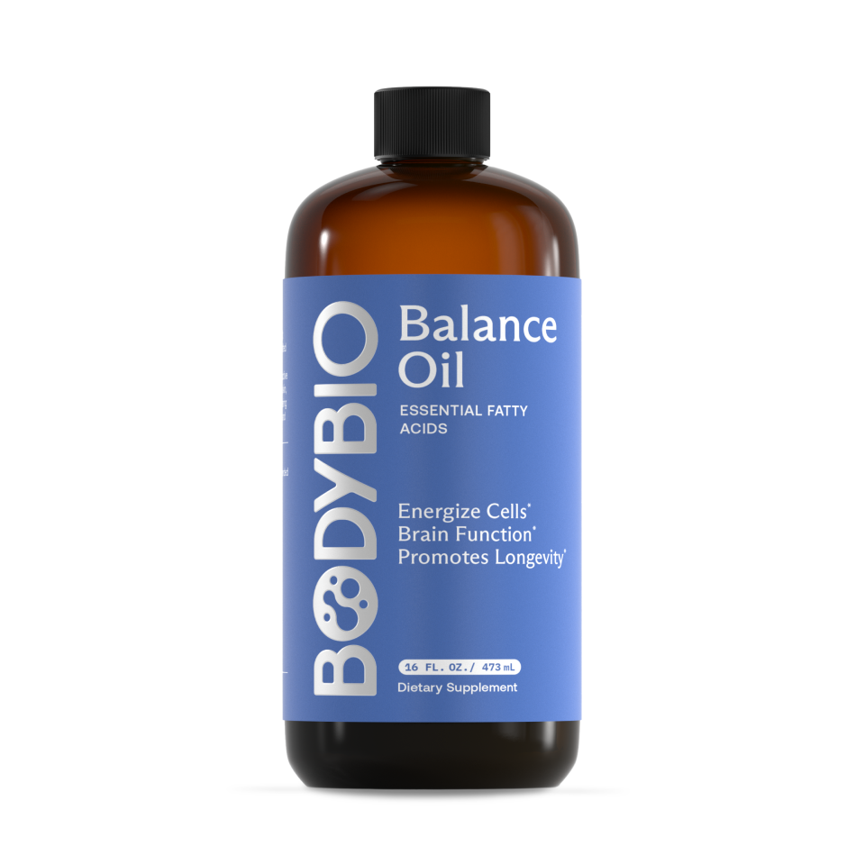 A brown bottle labeled Balance Oil (Omega 6 + 3) with a blue label promotes its function as a healthy fat supplement rich in essential fatty acids to energize cells, support brain function, and promote longevity. The bottle contains 16 fl. oz. (473 mL).