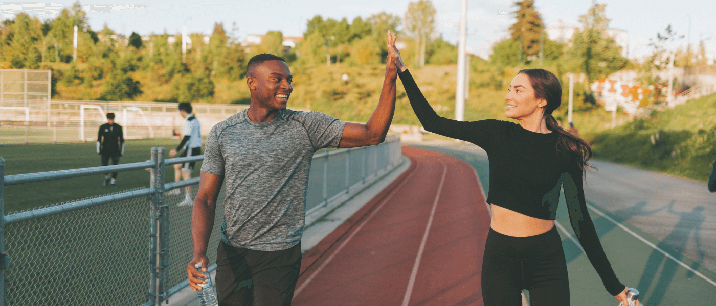 Two fitness friends high fiving