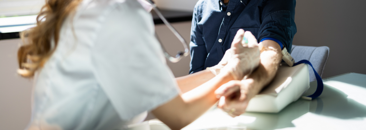 Blog of Fatty Acid Testing: What It Is, How It Works, and 5 Key Health Insights which have image A medical professional in a white coat is drawing blood from a patient's arm using a syringe.