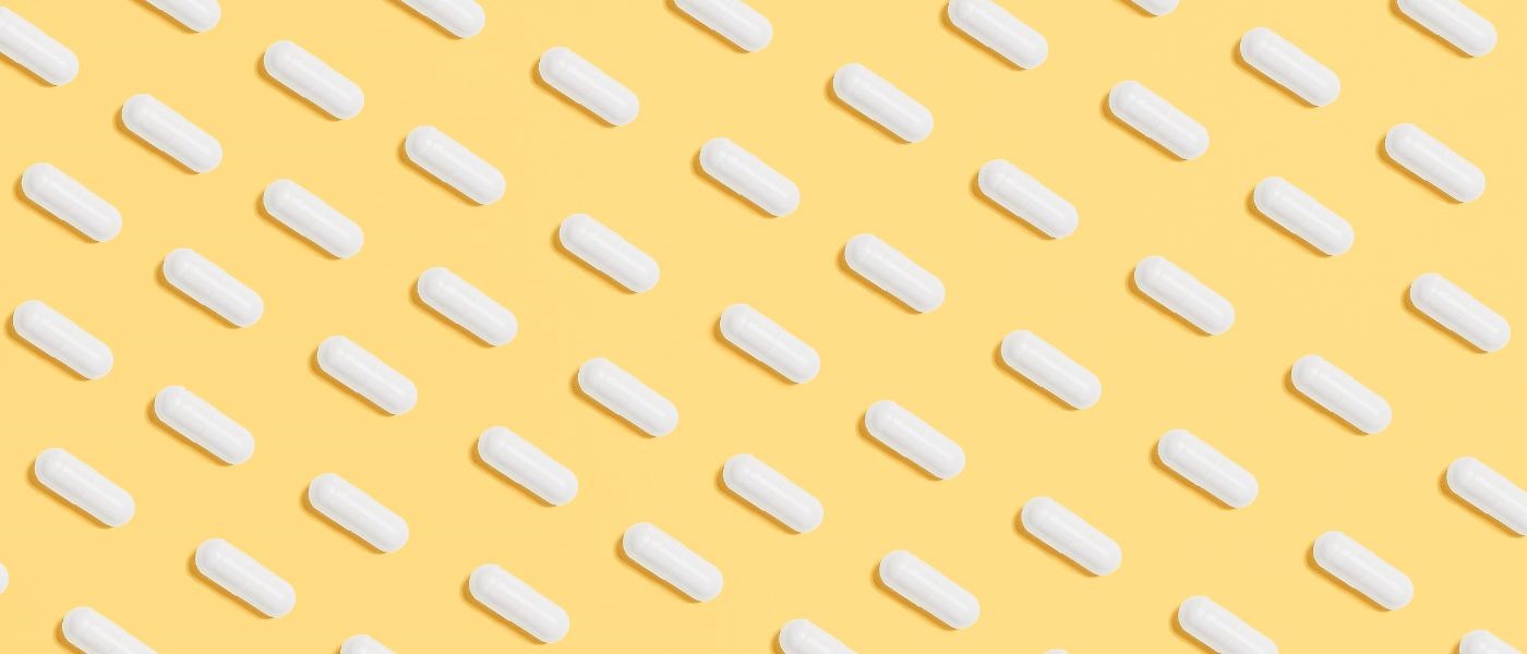 white pills on a yellow background