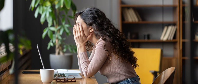 Blog of Why Do Energy Drinks Make Me Tired? How to Support Consistent Energy Levels which have image tired woman at desk