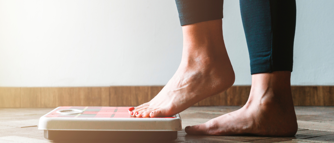 person stepping onto scale