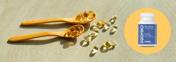 BodyBio Resolvin supplement with softgels on wooden spoons