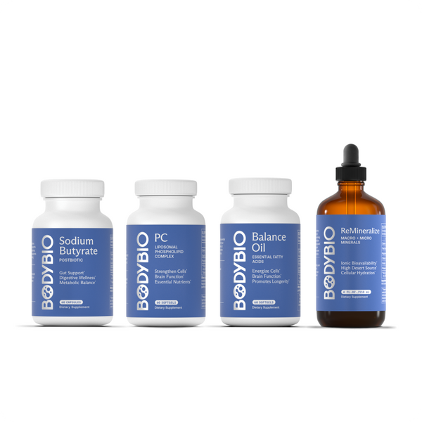 Four Cell Essentials supplement bottles are lined up: Sodium Butyrate, PC, Balance Oil, and ReMineralize. Three are white plastic bottles, and one is an amber glass bottle with a dropper. All feature white labels with blue accents, highlighting foundational nutrients designed to support cellular health and promote optimal cell membrane function.